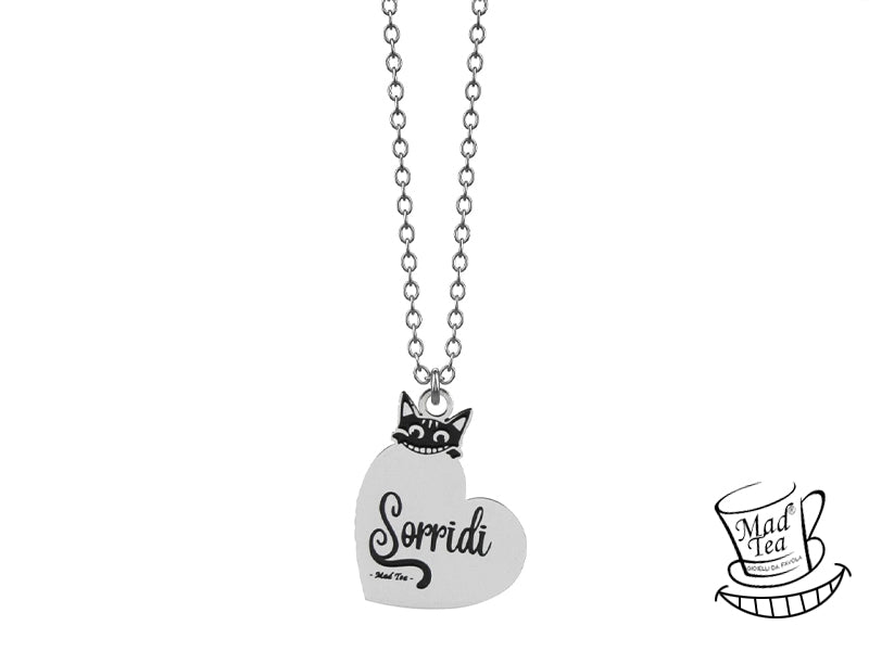 Collana con ciondolo a forma di cuore con il Gatto del Cheshire che spuntando da dietro lascia che la sua magica coda componga la lettera iniziale “S” della parola “Sorridi”.
