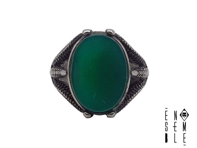 Questo anello combina un tradizionale design a sigillo con uno stile moderno, caratterizzato da pietra color verde a contrasto sull'acciaio inossidabile