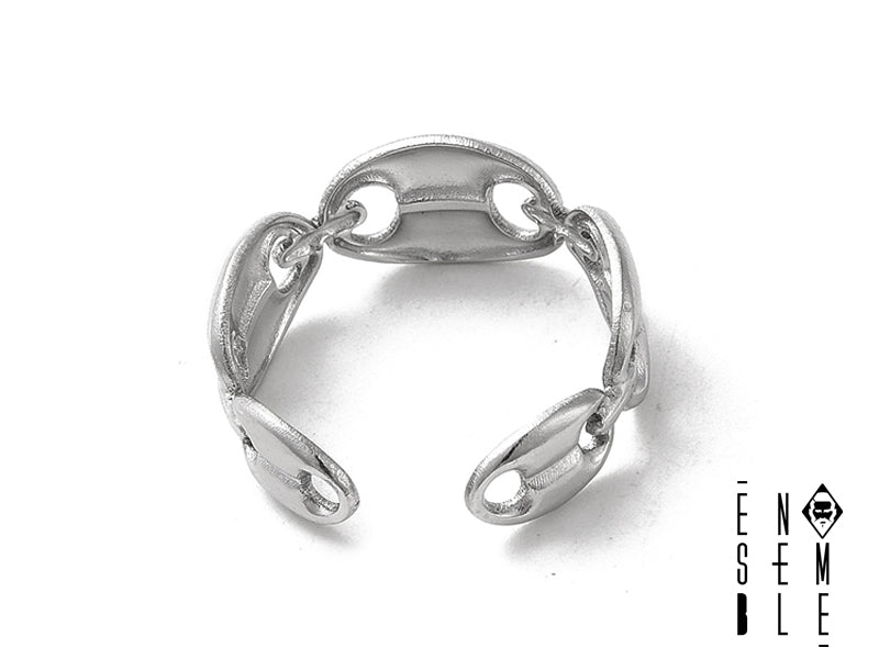 Un frammento di costa selvaggia, catturato in un anello. I chicchi di caffè, trasportati dalle onde, si sono fusi nell'acciaio, creando un'alleanza tra la forza della natura e l'eleganza dell'uomo. Un gioiello che sussurra storie di viaggi e avventure