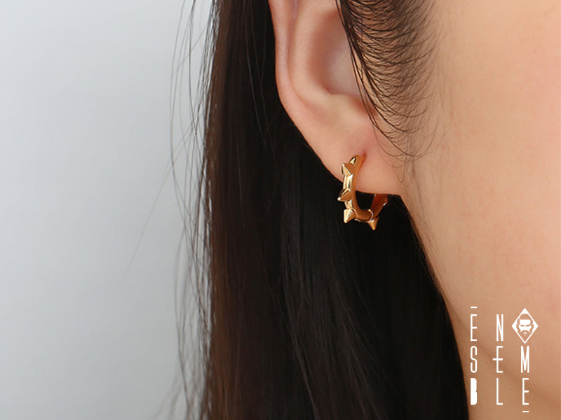 Un tocco di ribellione per il tuo orecchio! Questo mono orecchino a cerchio in acciaio inossidabile, impreziosito da sei borchie, è l'accessorio perfetto per chi ama esprimere la propria personalità con audacia e originalità. Un simbolo di forza e stile, per un look che non passa inosservato.