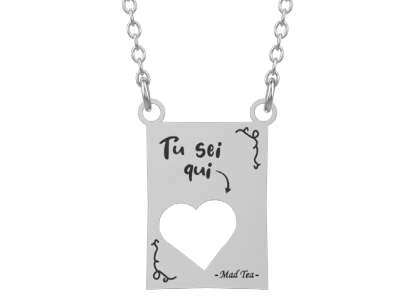 Collana con ciondolo con incisa la scritta "Tu sei qui" e un piccolo cuore traforato.