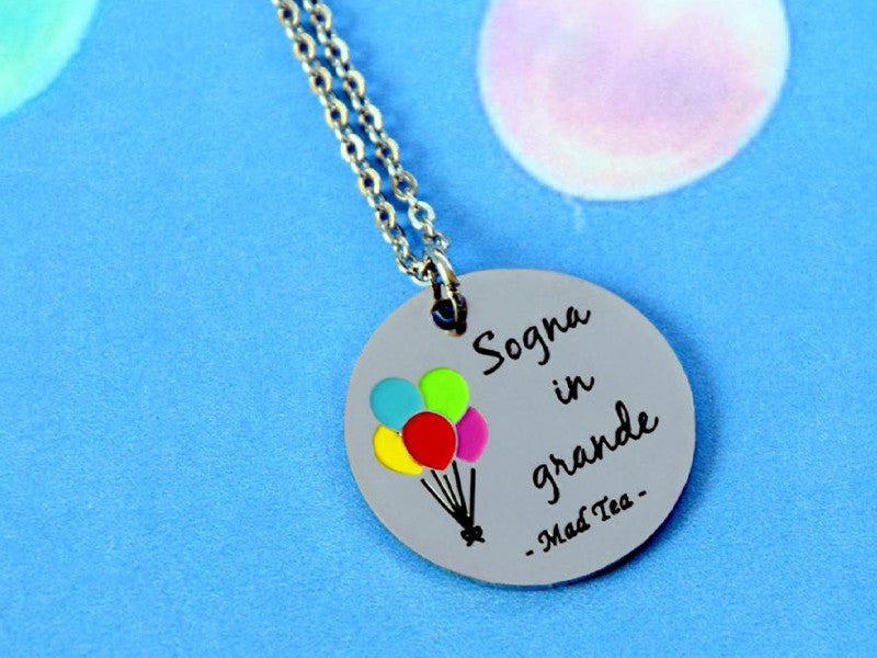 Collana con dolce targhetta con incisa la frase "Sogna in grande" e tanti piccoli palloncini colorati.  Lunghezza: 38 cm 