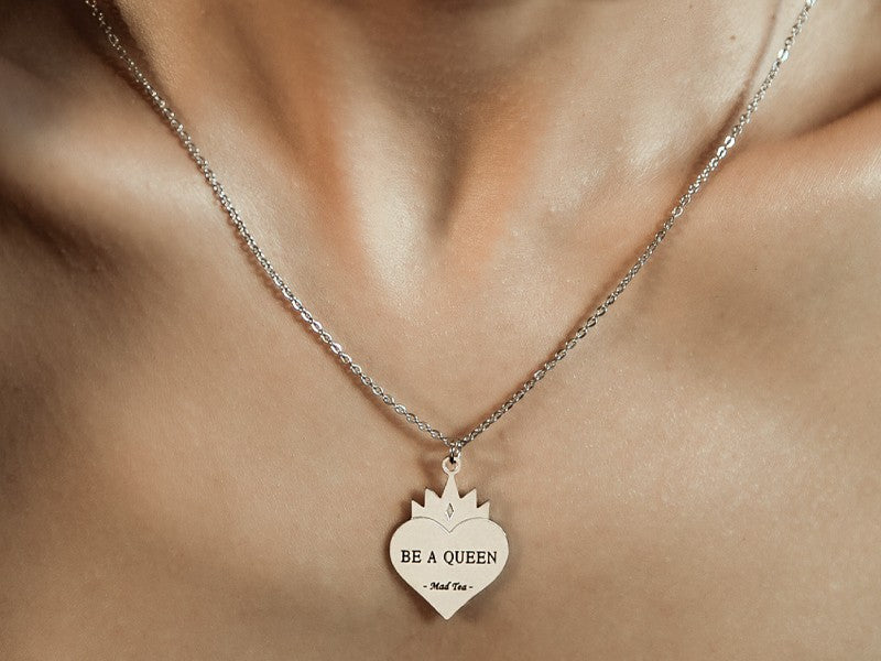 Collana con ciondolo a forma di cuore sovrastato dalla corona della regina con all'interno incisa la frase "BE A QUEEN" per sentirsi una vera regina.