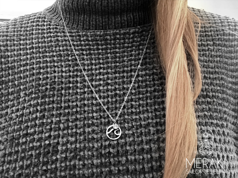 Collana con punto luce e onda in acciaio