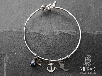 Bracciale bangle con ancora, delfino e cavalluccio marino