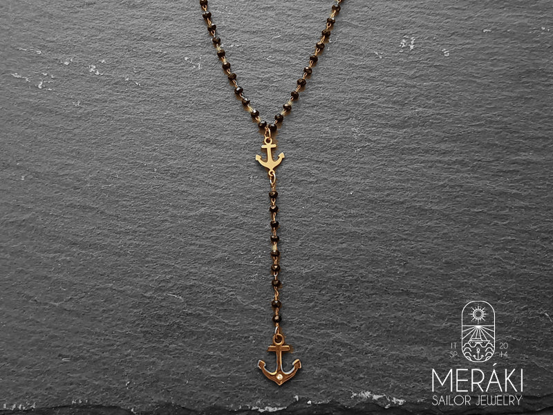 Collana rosario in acciaio rosato con ancorette e punto luce