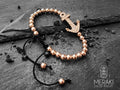 Bracciale in cortdino cerato nero e perline, ancora in acciaio rosato